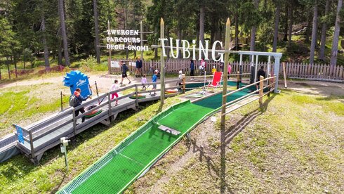 Sunny tobogganing fun within sight of the "Three Peaks"